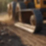 Detailed view of a tractor grader blade in action
